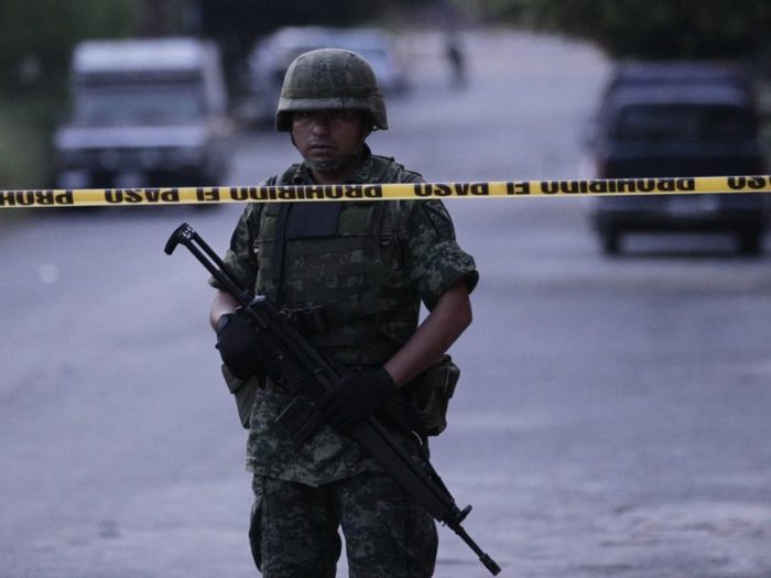 A soldier standing guard at the site of a car-bomb attack outside the broadcaster Televisa in Ciudad Victoria, Mexico