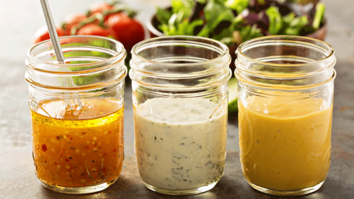 small jars with salad dressing